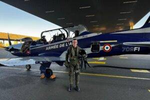 Élève officier sous contrat de la promotion OSC 24 Charlie en stage à l'école de l'aviation de chasse de Cognac, posant devant un Pilatus PC-21